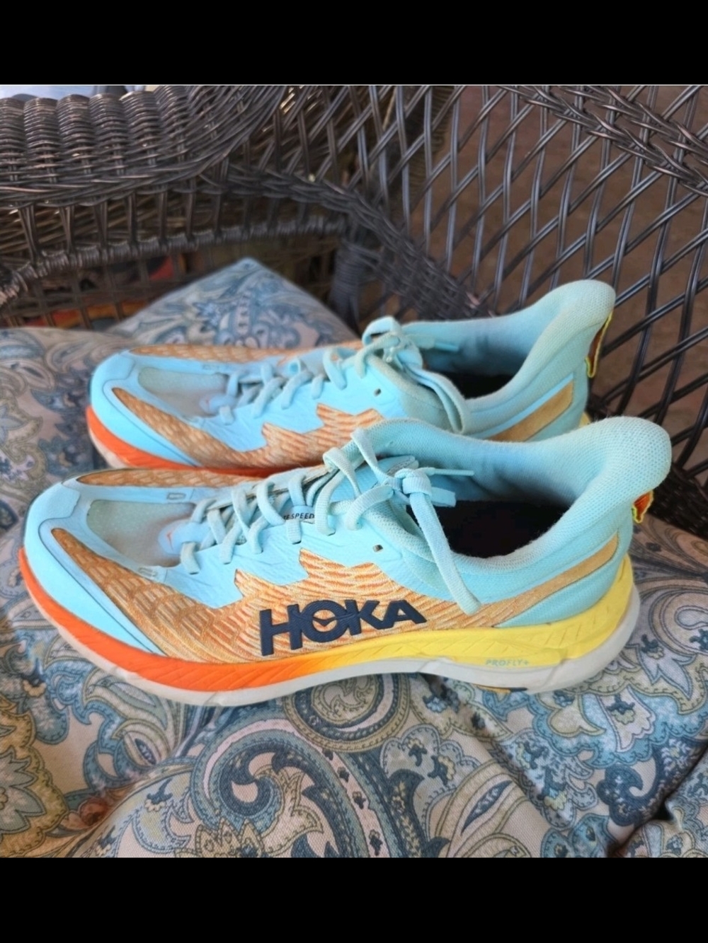 Hoka Mafate Speed 4 trail running shoes featuring a distinctive orange and light